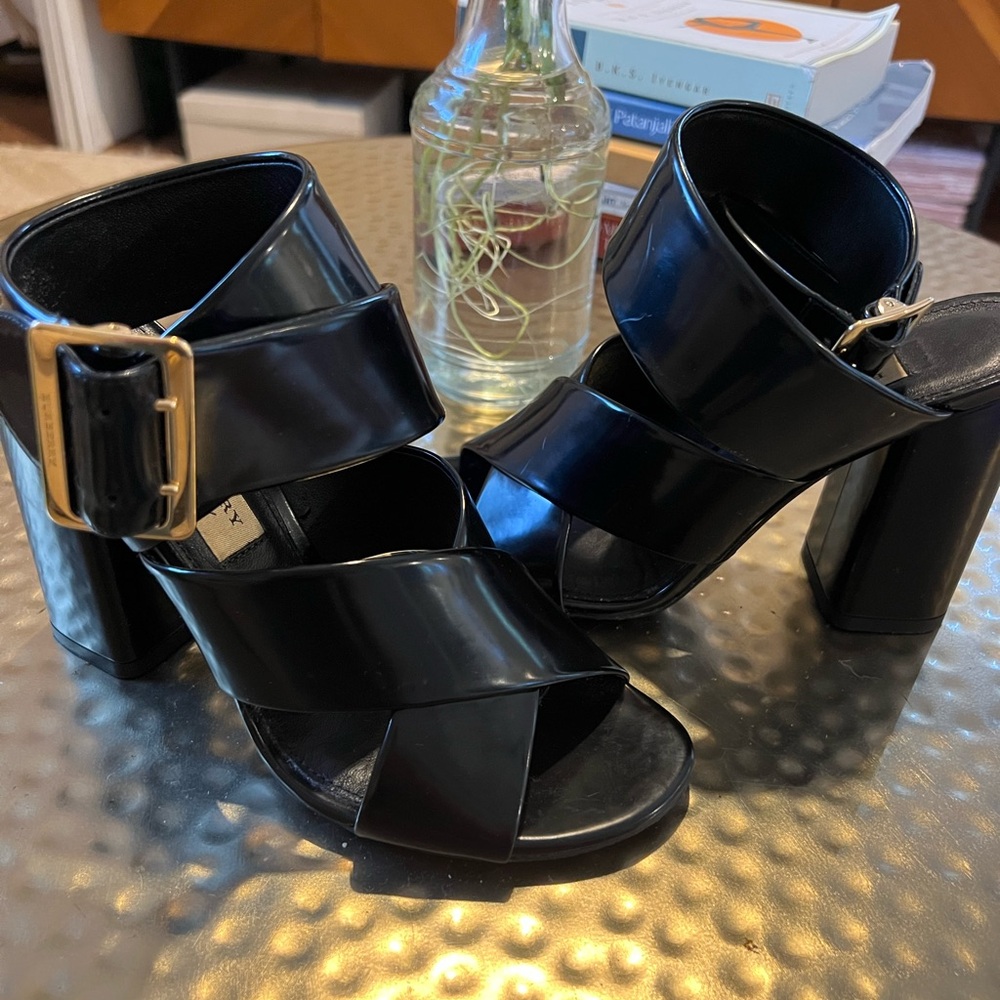 Block heel sandal with gold buckle and ankle strap.